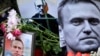 Flowers are seen placed around portraits of late Russian opposition leader Aleksei Navalny at a makeshift memorial in front of the former Russian consulate in Frankfurt, Germany, on February 23.