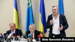 Crimean Tatar leaders Ilmi Umerov (left) and Akhtem Chiygoz (right) appear with Ukrainian lawmaker Mustafa Dzhemilev at a news conference at Boryspil International Airport outside Kyiv on October 27.