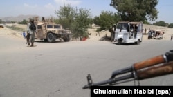 Afghan security forces stop vehicles at a checkpoint in Jalalabad.