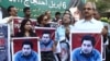 At a rally in Karachi in April 2017, protesters hold up portraits of 23-year-old Mashal Khan, who was killed by a mob of fellow students for alleged blasphemy at Abdul Wali Khan University.