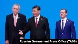 Czech President Milos Zeman (left), Chinese President Xi Jinping (center), and Russian Prime Minister Dmitry Medvedev (right) pose at the China International Import Expo in Shanghai.