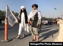 A Taliban fighter with an M16 assault rifle stands outside the Interior Ministry in Kabul on August 16.