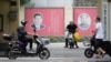 Portraits of Chinese President Xi Jinping (left) and the late Chinese leader Mao Zedong are seen on a street in Shanghai. Xi is poised to receive a third term as leader next month, something not done since Mao.