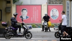 Portraits of Chinese President Xi Jinping (left) and the late Chinese leader Mao Zedong are seen on a street in Shanghai. Xi is poised to receive a third term as leader next month, something not done since Mao.