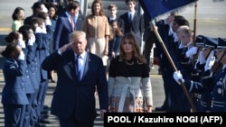 U.S. President Donald Trump and his wife, Melania, are welcomed upon arrival at the Yokota Air Base in western Tokyo on November 5.