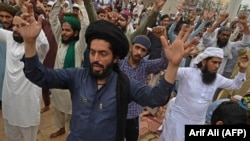 Supporters of the hard-line Tehrik-e Labaik Pakistan chant slogans as they block a street during a protest after their leader was detained following his calls for the expulsion of the French ambassador, in Lahore on April 16.