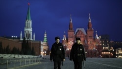 Police officers patrol a deserted Red Square.