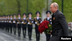 Russian President Vladimir Putin takes part in a flower-laying ceremony at the Tomb of the Unknown Soldier on Victory Day in Moscow.