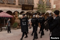 Police officers patrol the old city in Kashgar in China's Xinjiang Uyghur Autonomous Region.