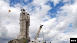 Children play in front of the unfinished "Peace and Brotherhood" sculpture in Kars on April 24.