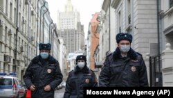 Russian police officers wearing face masks to protect against the coronavirus patrol an almost empty Arbat Street in Moscow amid a citywide lockdown on April 2. 