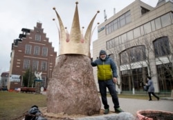 Street-art sculptor Aleksandr Pravdin stands next to his work, a 3-ton stone with a crown named The Monument To Russian President Vladimir Putin, in the Siversky settlement south of St. Petersburg on March 11.