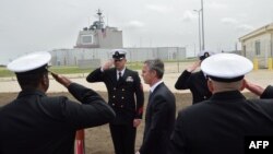 NATO Secretary General Jens Stoltenberg (center) reviews an honour guard during an inauguration ceremony for the U.S. antimissile site at a military base in Deveselu, Romania in May 2016. 