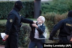 Opposition activist Nina Baginskaya, 73, fights with police at a rally in Minsk on August 26.