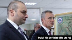 Georgian Prime Minister Mamuka Bakhtadze (left) and NATO Secretary-General Jens Stoltenberg at the Krtsanisi National Training Center outside Tbilisi on March 25