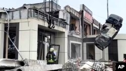 Rescuers in the occupied Ukrainian city of Lysychansk work at a bakery, which separatist authorities claim was hit in a Russian drone attack on February 3. 