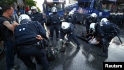 German riot police detain protesters during anticapitalist demonstrations ahead of the G20 summit in Hamburg on July 6.