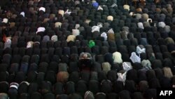 Shi'ite Muslim worshippers gather in prayer at the shrine of Imam Abbas to commemorate Ashura in Karbala, south of Baghdad, on November 13.