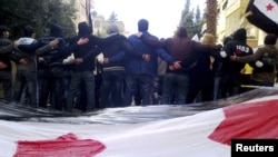 Antigovernment demonstrators protest in the city of Homs on January 9.