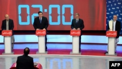 Afghan presidential candidates Qayum Karzai, Abdul Rahim Wardak, Zalmai Rassoul, and Ashraf Ghani Ahmadzai (left to right) take part in a debate at Tolo TV station in Kabul on February 4.