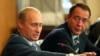 Mikhail Lesin (right) with Russian President Vladimir Putin in 2002