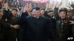 North Korean leader Kim Jong Un (center) is shown reportedly celebrating the successful test-firing of an intercontinental ballistic missile at an undisclosed location in this photograph released by North Korea's official Korean Central News Agency on July 5.