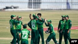 Pakistan's cricket team celebrates during the third one-day international match between Pakistan and Zimbabwe at the Rawalpindi Cricket Stadium on November 3.