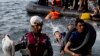 Migrants arrive on the shores of the Greek island of Lesbos after crossing the Aegean Sea from Turkey on a dinghy on September 9.