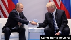 U.S. President Donald Trump shakes hands with his Russian counterpart, Vladimir Putin, at their first official meeting in Hamburg in July.