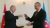 Azerbaijani President Ilham Aliyev receives prayer beads from his Turkish counterpart, Recep Tayyip Erdogan, during a meeting in Baku on February 25.