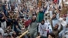 Supporters of Tehrik-e Labaik Pakistan, a banned Islamist party, chant slogans during a protest in Lahore on April 19 following the arrest of their party leader, Saad Rizvi, who had demanded the government expel the French ambassador.