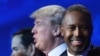 Republican Presidential hopefuls Marco Rubio (left), Donald Trump (center), and Ben Carson look on during a break in a Republican presidential debate in Boulder, Colorado.