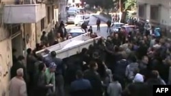 Mourners on January 3 carry the coffin of a man identified in a statement by the antiregime Local Coordination Committees as Abdel Jabbar Zaarur, reportedly killed in Homs.