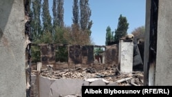 A burned down house in the village of Maksat in the Leilek region on May 2.