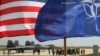 The U.S. and NATO flags fly in front of two U.S. Air Force F-22 Raptor fighter jets at the Lithuanian air base in Siauliai in April in a show of support for a region worried by Russian aggression in Ukraine.