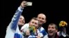 Russian fencer Sergei Bida (left) with teammates after winning a silver medal in the men's epee event at the Tokyo Olympic Games in 2021. 