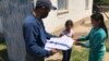 Kazakhstan – The postman Ryskan Nyatbekov gives the student teaching materials from school. Amangeldi village, Kazygurt district, Turkistan region. 30Apr2020