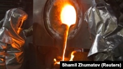 Workers pour molten gold from a crucible into moulds at the Kumtor gold mine.